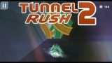 A sleek vehicle racing through a glowing neon 3D tunnel in Tunnel Rush 2